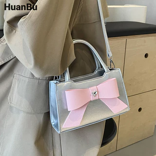 Huan Bu Túi vuông nhỏ dành cho nữ niche màu hồng cầm tay thời trang mới nơ túi đeo chéo đi lại cao cấp